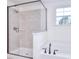 Bathroom showing the glass-enclosed shower and a soaking tub with black hardware for a sleek design at 111 Megby Trl, Statesville, NC 28677