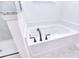 Close-up of the bathroom soaking tub with sleek black hardware adjacent to the glass enclosed shower at 111 Megby Trl, Statesville, NC 28677