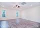 Spacious bedroom featuring hardwood floors, two windows allowing ample natural light, and ceiling fan at 111 Megby Trl, Statesville, NC 28677