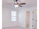 Bedroom showcasing a ceiling fan, a window for natural light, and an adjoining walk-in closet for ample storage at 111 Megby Trl, Statesville, NC 28677