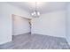 Bright dining area with hardwood floors, modern lighting and neutral paint at 111 Megby Trl, Statesville, NC 28677