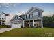 Beautiful blue home with a two-car garage and classic white trim at 111 Megby Trl, Statesville, NC 28677