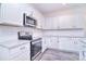 Well-equipped kitchen with stainless steel appliances, granite counters, and white cabinetry at 111 Megby Trl, Statesville, NC 28677