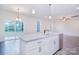 Bright, open kitchen with granite island, stainless appliances, and sliding glass doors at 111 Megby Trl, Statesville, NC 28677