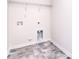 Bright laundry room features tile floor, white trim, and shelving for optimal organization and storage at 111 Megby Trl, Statesville, NC 28677