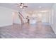 Open-concept living room featuring modern kitchen, hardwood floors, and stairs to the upper level at 111 Megby Trl, Statesville, NC 28677