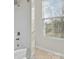 Bright bathroom with a tiled shower and a window to let in natural light at 1127 Central Park Cir, Davidson, NC 28036