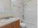 Bright bathroom with a tub-shower, single vanity, and neutral color palette at 1127 Central Park Cir, Davidson, NC 28036