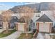 Townhome with attached garages, neutral siding, and well-kept lawns, offering convenient living at 1127 Central Park Cir, Davidson, NC 28036