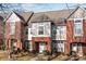 Townhome exterior with brick facade, multiple windows, and well-maintained landscaping at 1127 Central Park Cir, Davidson, NC 28036