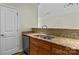 Kitchen with stainless steel dishwasher and sink, granite countertop, and wood cabinets at 1127 Central Park Cir, Davidson, NC 28036