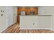 Open kitchen features stainless steel appliances, granite countertops, and wood cabinets at 1127 Central Park Cir, Davidson, NC 28036