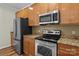 This kitchen offers stainless steel appliances, granite countertops, and wooden cabinets at 1127 Central Park Cir, Davidson, NC 28036