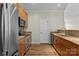 Well-equipped kitchen featuring stainless steel appliances, granite countertops, and wood cabinets at 1127 Central Park Cir, Davidson, NC 28036