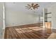 Bright living area with hardwood floors, ceiling fan, and neutral walls perfect for customization at 1127 Central Park Cir, Davidson, NC 28036