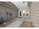 Back patio with gravel accents, a door to the home, and a large window at 1127 Central Park Cir, Davidson, NC 28036