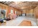 Unfinished basement with framed walls, exposed insulation, and a walkout door offers potential for customization at 114 Tomahawk Dr, Mooresville, NC 28117