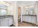 Bathroom with double sinks, granite counters, and wood-look tile floors at 114 Tomahawk Dr, Mooresville, NC 28117