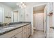 Well-lit bathroom featuring double vanity with granite countertop and a separate toilet with a shower at 114 Tomahawk Dr, Mooresville, NC 28117