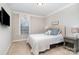 Comfortable bedroom with neutral decor, a plush bed, and ample natural light from the window at 114 Tomahawk Dr, Mooresville, NC 28117