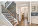 Elegant foyer featuring hardwood floors, staircase with iron railings, and stylish lighting at 114 Tomahawk Dr, Mooresville, NC 28117