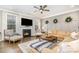 Cozy living room with a fireplace, television, hardwood floors and comfortable seating at 114 Tomahawk Dr, Mooresville, NC 28117