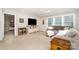 Comfortable carpeted living room area featuring a large TV and built-in shelves at 114 Tomahawk Dr, Mooresville, NC 28117