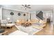 Spacious living room with wood paneling, hardwood floors, and comfortable seating at 114 Tomahawk Dr, Mooresville, NC 28117