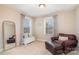 Cozy sitting room with windows for natural light, a mirror and leather chair at 114 Tomahawk Dr, Mooresville, NC 28117
