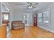 Warm living room features hardwood floors, a comfortable sofa, and views into the kitchen and dining area at 120 Benfield Rd, Statesville, NC 28677