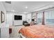 A sunlit bedroom with a tray ceiling, neutral walls, and a cozy bed, enhanced by a TV and dresser at 12224 Diablo St, Huntersville, NC 28078