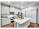 Modern kitchen with stainless steel appliances, white cabinets, and a spacious island at 12224 Diablo St, Huntersville, NC 28078