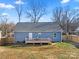 View of the rear exterior with a wooden deck, blue siding, and a fenced yard at 131 Lowry Row # 8, York, SC 29745