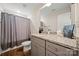 Modern bathroom features granite countertop, gray cabinetry, and a shower with gray curtain at 131 Lowry Row # 8, York, SC 29745
