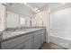 Bathroom with a dual-sink vanity, granite countertops, and a shower-tub combo at 131 Lowry Row # 8, York, SC 29745