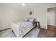 Cozy bedroom featuring a white wooden bed frame, floral bedding, and a small wooden stool at 131 Lowry Row # 8, York, SC 29745