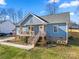 Charming single-Gathering home featuring a quaint front porch, light blue siding and a well-manicured lawn at 131 Lowry Row # 8, York, SC 29745