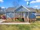 Charming single-Gathering home featuring a quaint front porch, light blue siding and a well-manicured lawn at 131 Lowry Row # 8, York, SC 29745