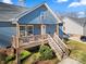 Charming blue home with a wooden porch and stairs, offering curb appeal and outdoor space at 131 Lowry Row # 8, York, SC 29745