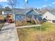 Charming blue home with a inviting front porch and a well-maintained lawn at 131 Lowry Row # 8, York, SC 29745