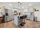 Modern kitchen with gray cabinets, granite countertops, stainless steel appliances, and a functional center island at 131 Lowry Row # 8, York, SC 29745