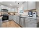 Well-lit kitchen featuring gray cabinets, granite countertops, and stainless steel appliances at 131 Lowry Row # 8, York, SC 29745