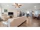Bright, open-concept living room flowing into a modern kitchen, featuring wood floors and neutral tones at 131 Lowry Row # 8, York, SC 29745
