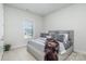 Cozy bedroom with soft gray tones, plush bedding, and ample natural light, creating a peaceful atmosphere at 1369 Dali Blvd, Mount Holly, NC 28120