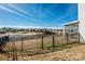 Scenic backyard view with a black fence, overlooking a tranquil lake and community at 140 Jana Dr, Statesville, NC 28677