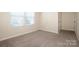 Bright bedroom with neutral walls and carpet, with natural light from the windows and door at 140 Jana Dr, Statesville, NC 28677
