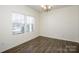 Well-lit bedroom with hardwood floors, and a large window providing natural light at 140 Jana Dr, Statesville, NC 28677