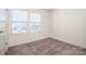 Bedroom featuring plush carpet, bright windows, and neutral walls at 140 Jana Dr, Statesville, NC 28677