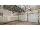 Spacious garage with two doors, storage racks, and ample ceiling height at 140 Jana Dr, Statesville, NC 28677