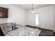 Bright eat-in kitchen features granite countertops, stainless sink, and door to the backyard at 140 Jana Dr, Statesville, NC 28677
